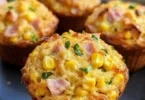 Freshly baked Savoury Ham and Corn Muffins on a wooden table
