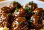 Slow Cooker Salisbury Steak Meatballs served with gravy and mashed potatoes
