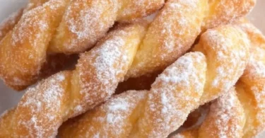 Freshly made soft and crispy twisted donuts on a platter