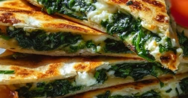 Spinach and feta quesadillas on a plate, garnished with herbs