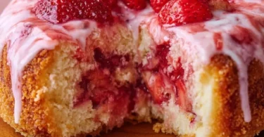 Delicious strawberry cream dessert topped with fresh strawberries and cream
