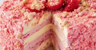 Delicious strawberry shortcake cheesecake topped with fresh strawberries and whipped cream.