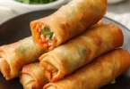 Ultra crispy chicken spring rolls served with dipping sauce