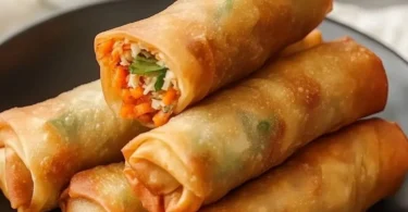 Ultra crispy chicken spring rolls served with dipping sauce