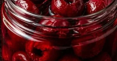 Jar of Very Vanilla Bean Pickled Cherries with a vanilla pod