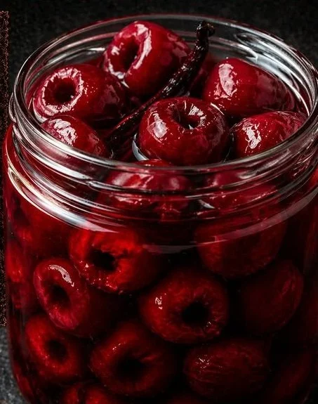 Jar of Very Vanilla Bean Pickled Cherries with a vanilla pod