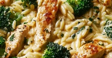 Delicious Cheesy Chicken Broccoli Orzo served in a bowl, showcasing creamy texture and vibrant colors.