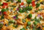 Delicious Chicken Burrito Casserole topped with cheese and fresh ingredients