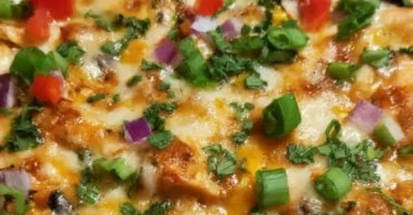 Delicious Chicken Burrito Casserole topped with cheese and fresh ingredients
