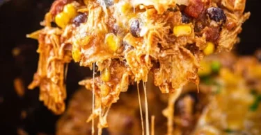 Crockpot Chicken Enchiladas Casserole topped with cheese and cilantro