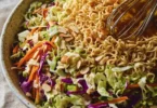 Bowl of Crunchy Ramen Noodle Salad with colorful vegetables and dressing