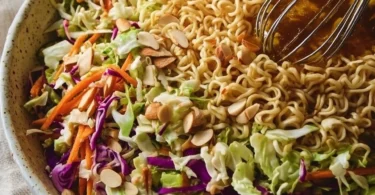Bowl of Crunchy Ramen Noodle Salad with colorful vegetables and dressing