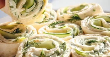 Cucumber Dill Pinwheels arranged on a platter, a fresh appetizer option.