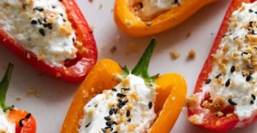 Cream cheese stuffed mini bell peppers displayed on a plate