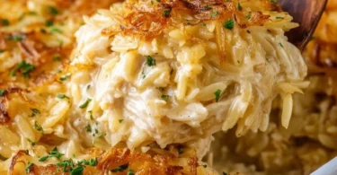 Delicious French Onion Chicken Orzo Casserole topped with melted cheese