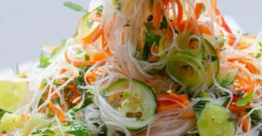 Bowl of fresh Vietnamese noodle salad with vegetables and herbs