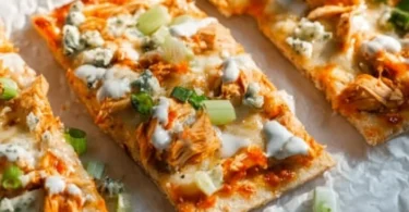High protein buffalo chicken flatbread topped with fresh ingredients.