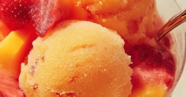 Delicious Mango Strawberry Sorbet in a bowl with fresh fruit garnish