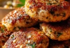 Delicious Mediterranean chicken patties served on a plate with fresh herbs
