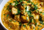 Slow Cooker Chicken Korma with spices and herbs served in a bowl