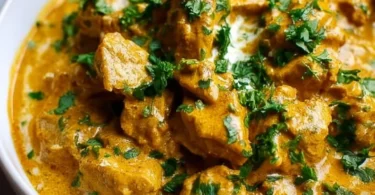 Slow Cooker Chicken Korma with spices and herbs served in a bowl