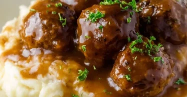 Slow Cooker Salisbury Steak Meatballs served with gravy and mashed potatoes