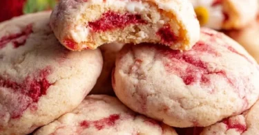 Strawberry cheesecake cookies on a plate with fresh strawberries