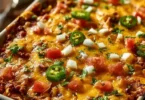 Delicious Taco Bake Casserole topped with cheese and fresh ingredients
