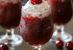 Delicious Cherry Rum Slushie in a glass with cherry garnish