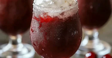 Delicious Cherry Rum Slushie in a glass with cherry garnish