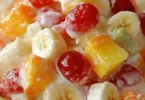 Colorful fruit cocktail salad with assorted fresh fruits.