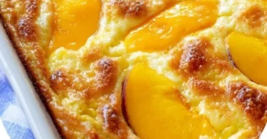 Peaches & Cream Cottage Cheese Breakfast Bake in a baking dish topped with fresh peaches